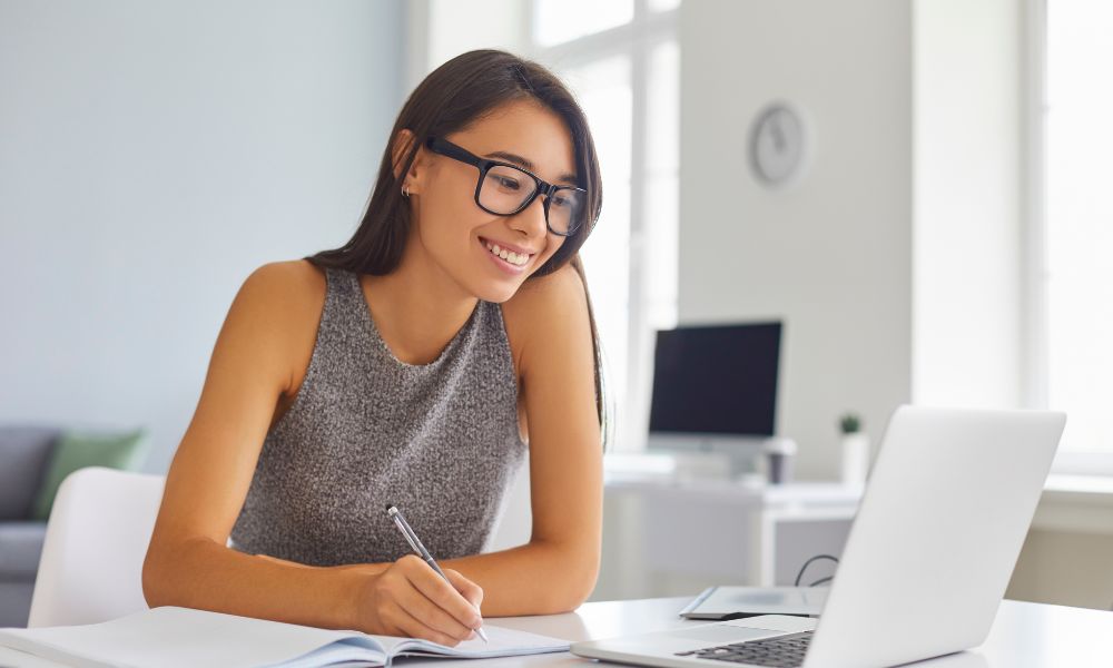 Woman sitting at desk looking at computer screen